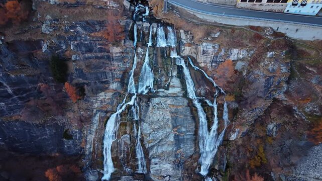 Aerial view of the Cascata del Toce waterfall cascading down the rugged cliffside, creating a mesmerizing display of nature's power, Formazza, Piedmont, Italy.
