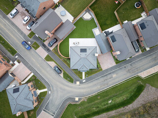 Drone top down view of a selection of new, luxury homes seen on a once brownfield site in rural Essex, UK. Solar panels are featured on the new homes as well as heat pumps.
