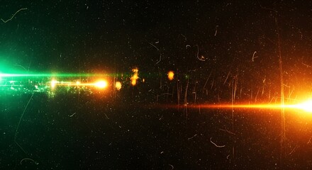 Abstract background with green and orange light streaks and lens flare effect, simulating a cosmic or futuristic scene with glowing particles and dust