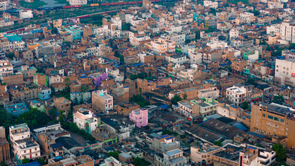 Obraz premium Top down Buildings and Apartment with Multiple Building aerial. Urban Buildings and Apartment at bridge road at Delhi. Cinematic cityscape drone shot. Noida Buildings.