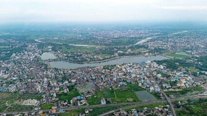 Fototapeta premium Top down Buildings and Apartment with Multiple Building aerial. Urban Buildings and Apartment at bridge road at Delhi. Cinematic cityscape drone shot. Noida Buildings.