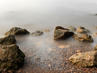 Long exposure rocks on a stony beach