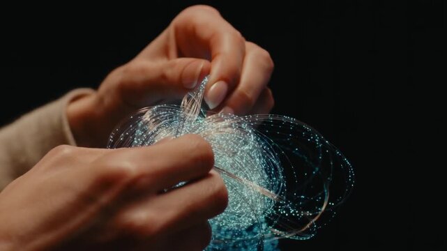 Hands untangling a complex knot of glowing threads in macro view, laying each strand into neat coils. Metaphor for therapy organizing chaotic thoughts and emotions.