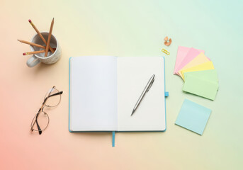 Open notebook with writing tools and glasses