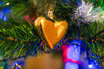 A shiny heart-shaped ornament adds a touch of love and warmth to the holiday season