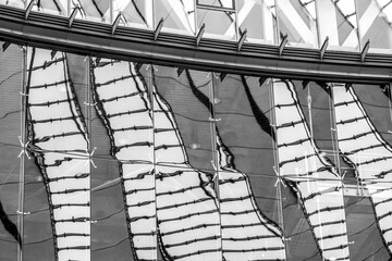 Geometry and structure defining a minimal architecture facade where lines create a rhythmic pattern across the building detail shown in an abstract cold exterior with clean modern linear arrangement