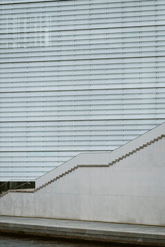 A minimal exterior where modern architecture highlights facade geometry, linear structure, subtle pattern and abstract detail with soft texture through clean daylight and a quiet spatial composition