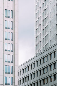 Modern architecture with layered facade elements where geometry, minimal structure, texture and abstract detail align across vertical patterns under soft daylight in a calm contemporary cityscape