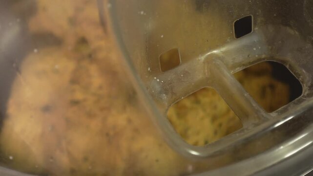 Machine kneading the integral dough with seeds in a bakery