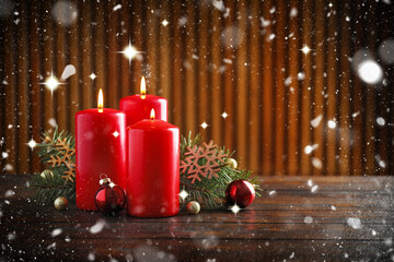 Christmas composition with candles on table against blurred background. Greeting card design