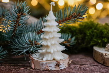 handmade soy wax candles in the cozy room, Christmas lights in the background. 