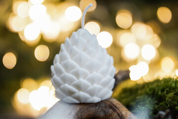 handmade soy wax candles in the cozy room, Christmas lights in the background. 