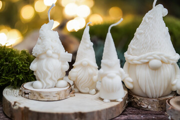 handmade soy wax candles in the cozy room, Christmas lights in the background. 