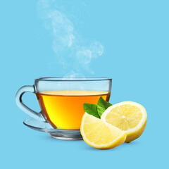 Hot lemon beverage in glass cup and fresh citrus fruit on light blue background. Health boosting drink for cold season