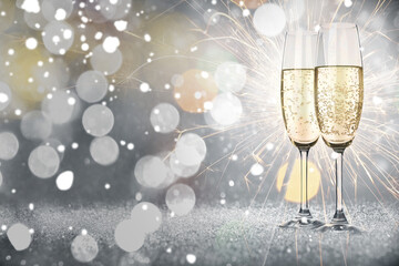 Happy New Year and Merry Christmas greeting card with glasses of sparkling wine and bokeh lights