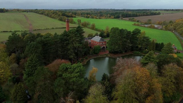 Aerial view of Papplewick Pumping Station surrounded by lush green fields and autumn foliage, Nottingham, England, United Kingdom.