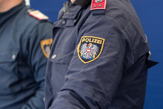 The Polizei patch is placed on the sleeve of a police uniform worn by a police officer ; Austria, Vienna, October 26, 2025.
