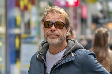 Fototapeta premium A fifty-year-old European man is on a busy street in the city center.