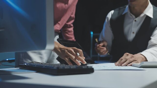 Business woman, men and night with computer, management and review in web design or teamwork. Colleagues, technology and working late on project deadline for digital agency, coworking space or office