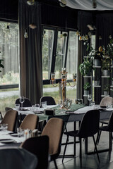 Elegant restaurant interior with candelabra and decorated dining tables