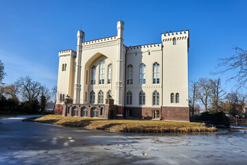 A moated, neo-Gothic, historic castle with towers in the town of Kórnik