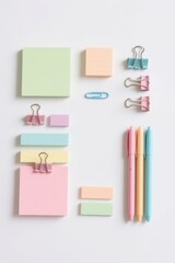 Arranged Pastel Stationery on White Surface with Copy Space and Overhead Perspective