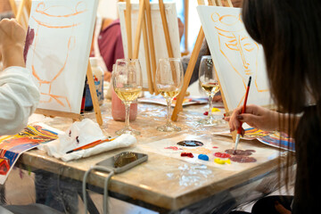 Friends enjoying creative sip and paint workshop