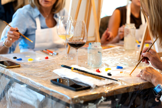 Women enjoying sip and paint workshop hobby