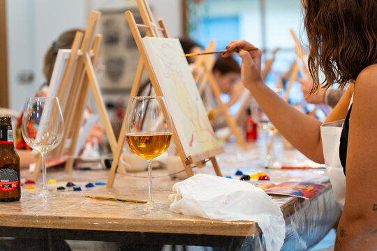 People enjoying sip and paint art workshop