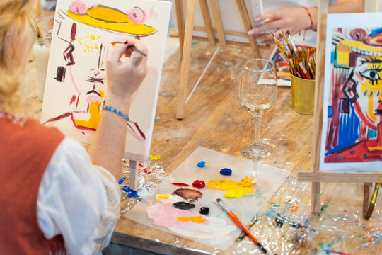 People enjoying painting in a creative sip and paint workshop