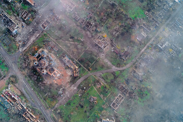 An aerial view of a heavily damaged residential neighborhood and a destroyed church dome and structure, following Russian shelling during the war in Ukraine. Scale of destruction and war crimes.