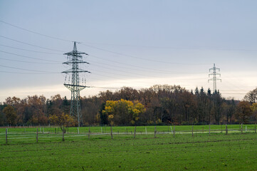 Electricity pylon transmitting power over green field