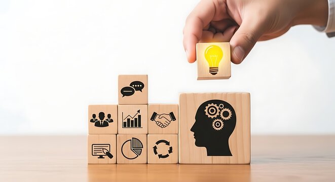 Brainstorming brilliant business ideas, a hand places a glowing lightbulb block atop a stack symbolizing innovation and strategic thinking.