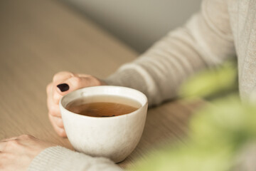 Woman holding cup of tea