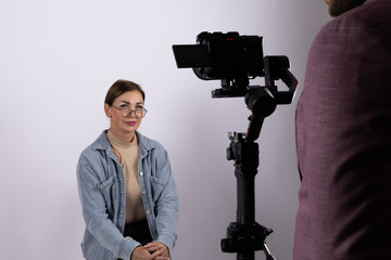 Woman is being filmed for what could be a journalistic interview or report