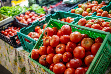 Fresh red tomatoes filling market crates for sale