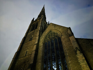 Gothic church St Mary, Upper Moss Lane, Hulme tower and stained glass facade in Manchester UK architectural photograph exterior