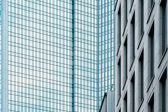 Corporate modern architecture and skyscraper facade show geometry and reflection on glass structure within urban design marked by strong vertical lines