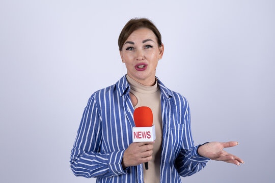 The news reporter is speaking into a microphone during a broadcast