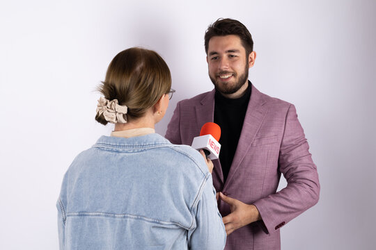 A journalist is interviewing a man with a microphone