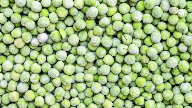 Close-up View of Frozen Green Peas Showing Natural Texture and Icy Surface