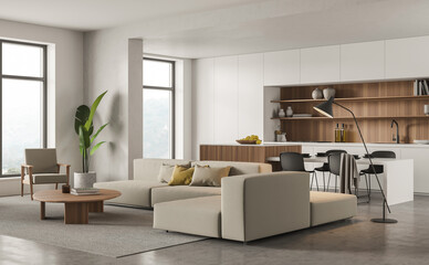 Corner view with sofa from white panoramic kitchen with wooden splashback