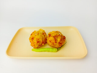 Bala-Bala or vegetable fritters with chili served on a plate, isolated on white background.