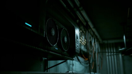 A system of wires and cooling fans fills the dark space, creating an atmosphere of technology and innovation. The glow from the device hints at the power within, inviting curiosity.