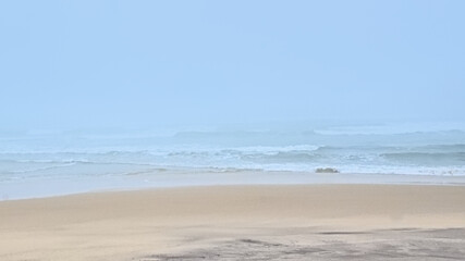 misty beach along the Atlantic ocean on a summer morning in Over, Portugal