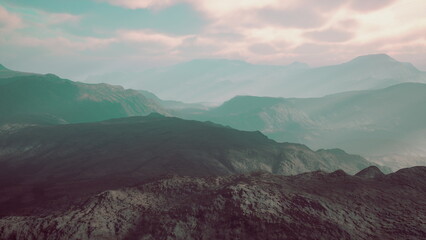 A breathtaking landscape reveals rolling mountains bathed in soft hues as twilight approaches. The misty valleys create a serene and peaceful atmosphere, inviting exploration of natures beauty.