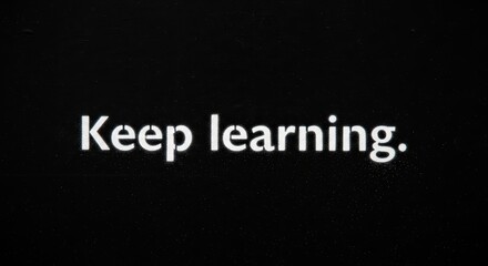 Inspiring motivation quote on black background: keep learning
