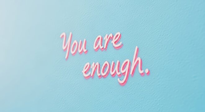 Inspirational pink message on light blue background: you are enough