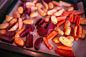 Freshly made homemade colorful healthy organic oven-roasted root vegetables including beets, carrots and potatoes