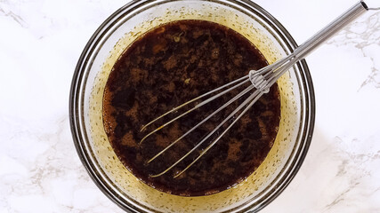 Whisk Mixing Dark Liquid Baking Mixture